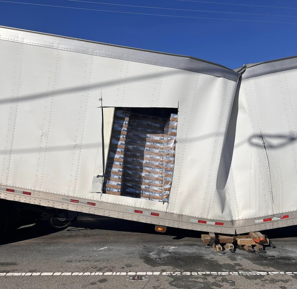 Semi trailer hauling Busch Light beer collapses after crossing railroad tracks