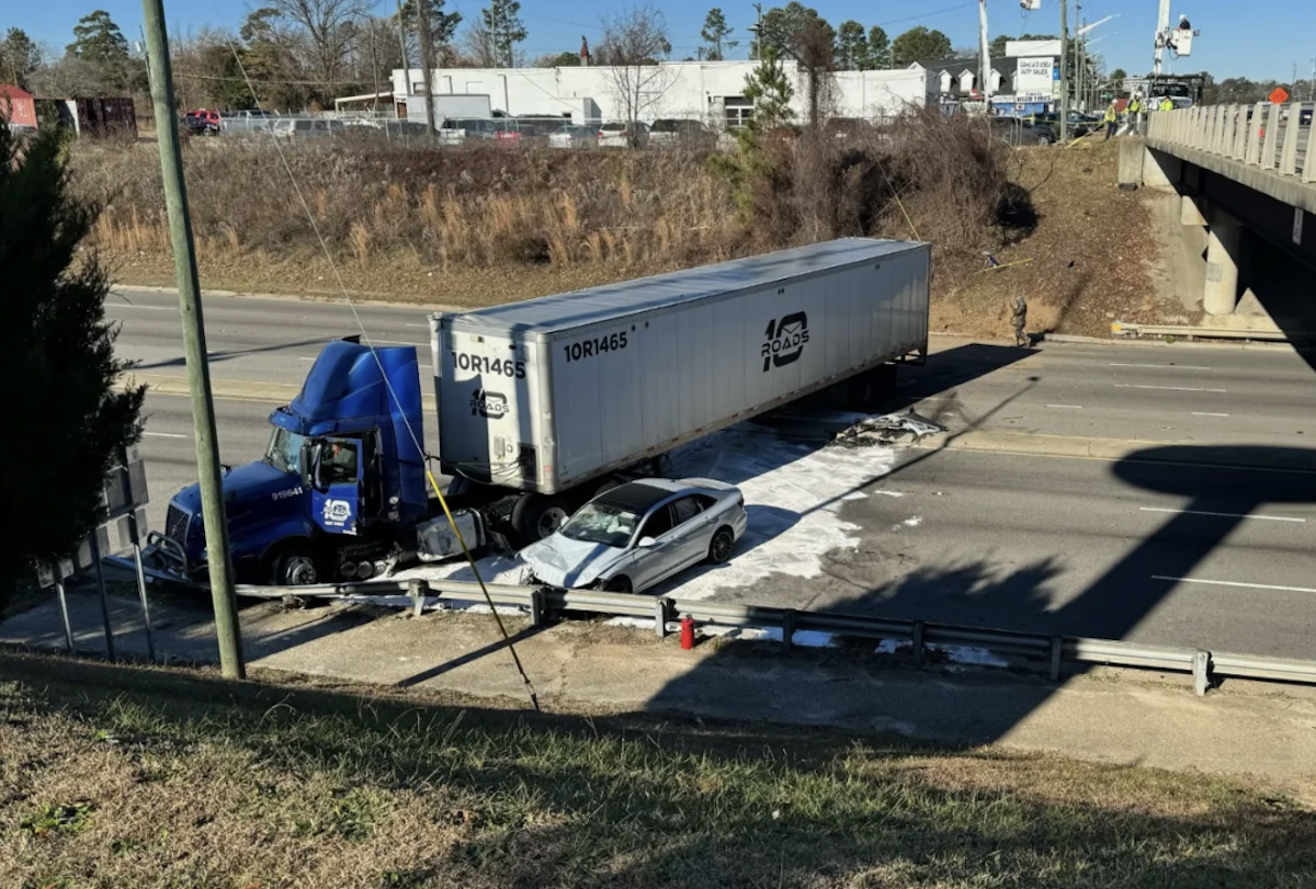 Rig goes rolling down embankment and bumps into car