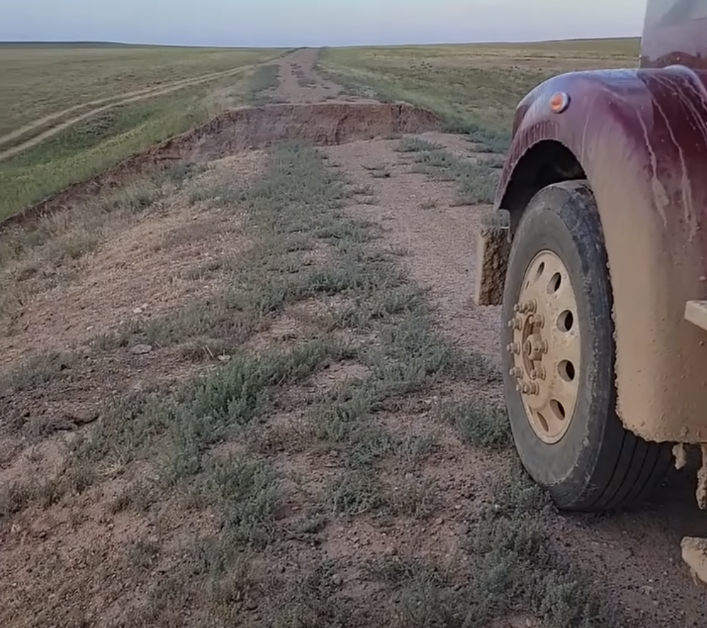 VIDEO: Trucker gets stranded on a washed out dirt road