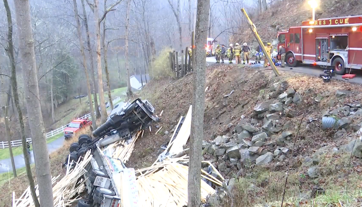 Truck driver missing after lumber truck slides down hill