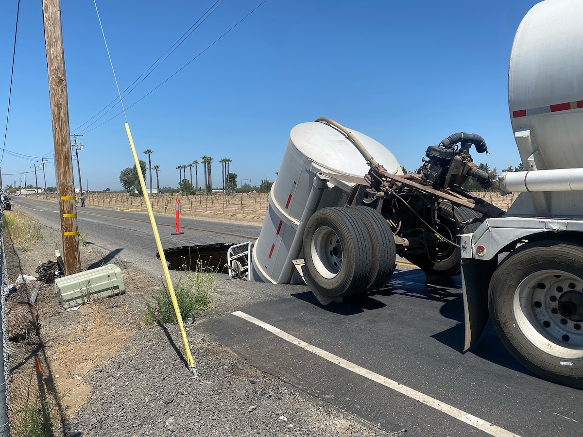 Sinkhole completely swallows rear trailer as semi hauls double tankers