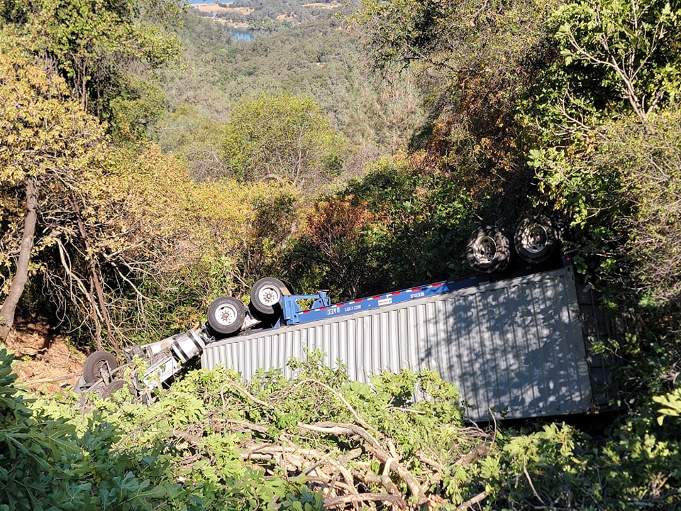 Truck driver rescued by California firefighters after tumbling down steep embankment