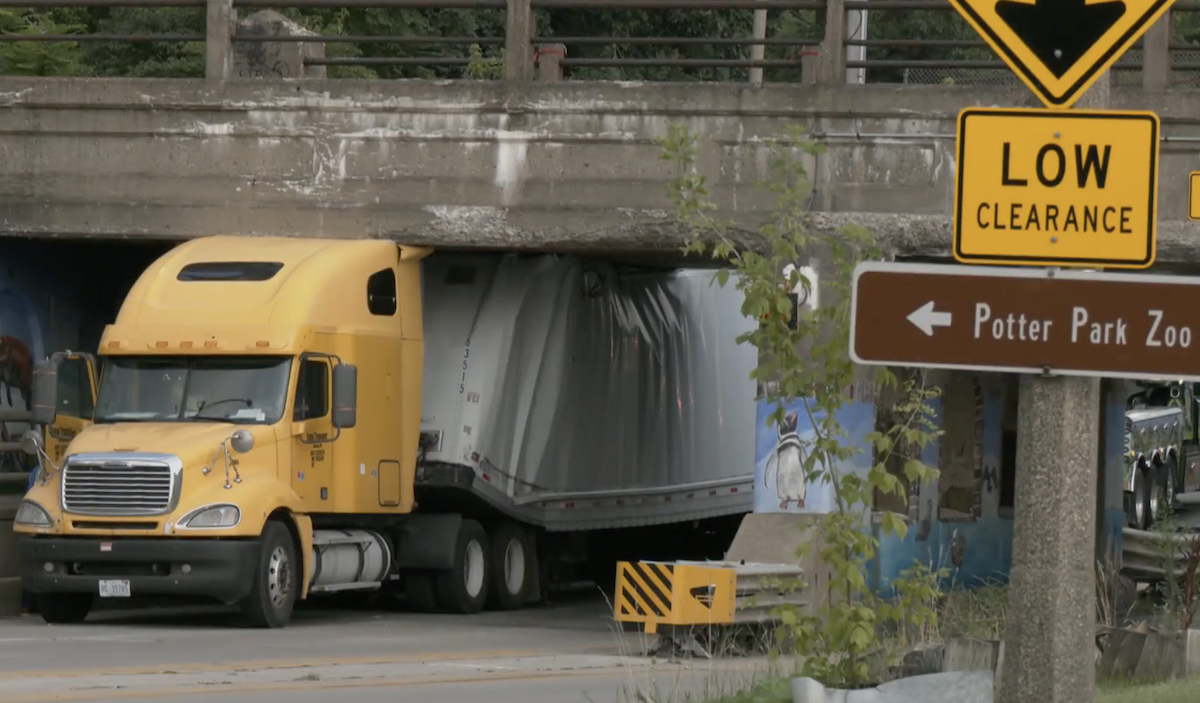 Semi truck gets stuck under Penn. Ave bridge