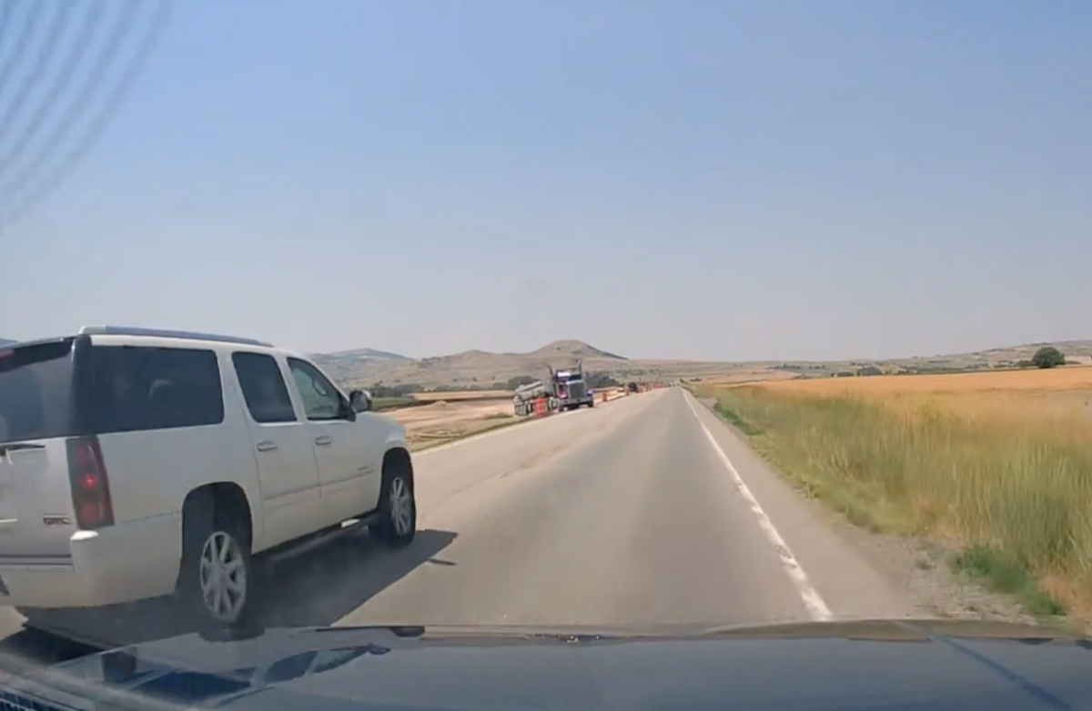 SUV nearly gets creamed by semi while making dangerous pass