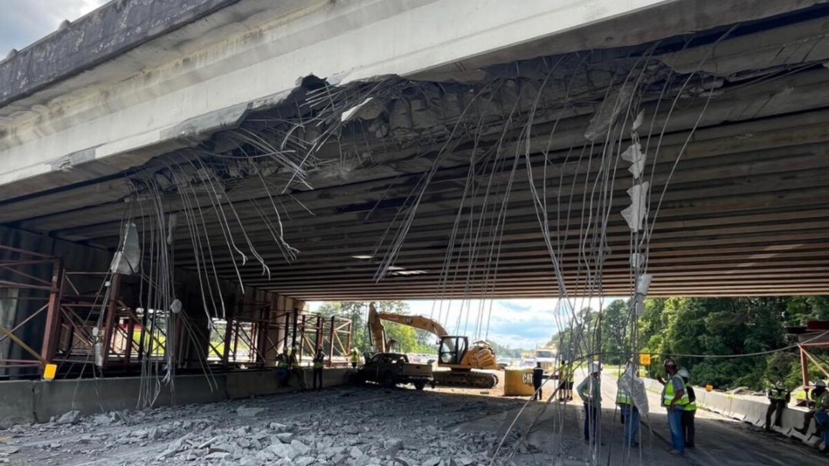 Truck hauling construction equipment strikes overpass, I-16 shut down