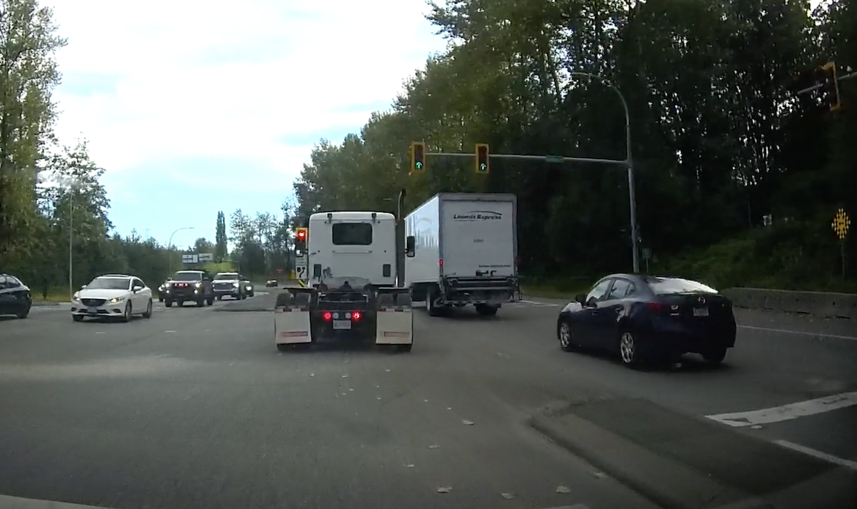 Bobtail imitates four-wheeler by forcing its way into moving traffic from the turn lane