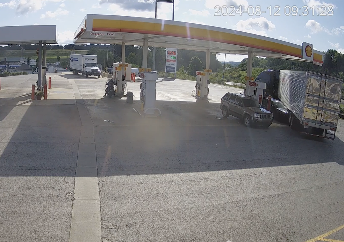 Trucker tries to just drive away after crunching luxury car at fuel island