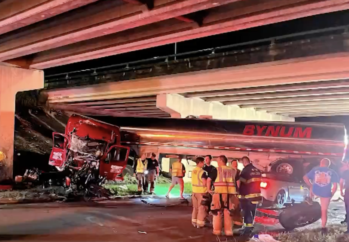 Tractor trailer lands on four-wheeler after skidding off overpass