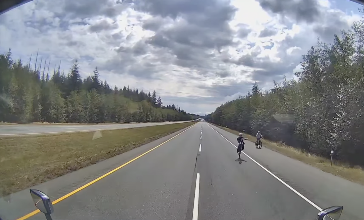 Dash cam shows trucker taking evasive action to avoid kid doing wrong-way wheelie