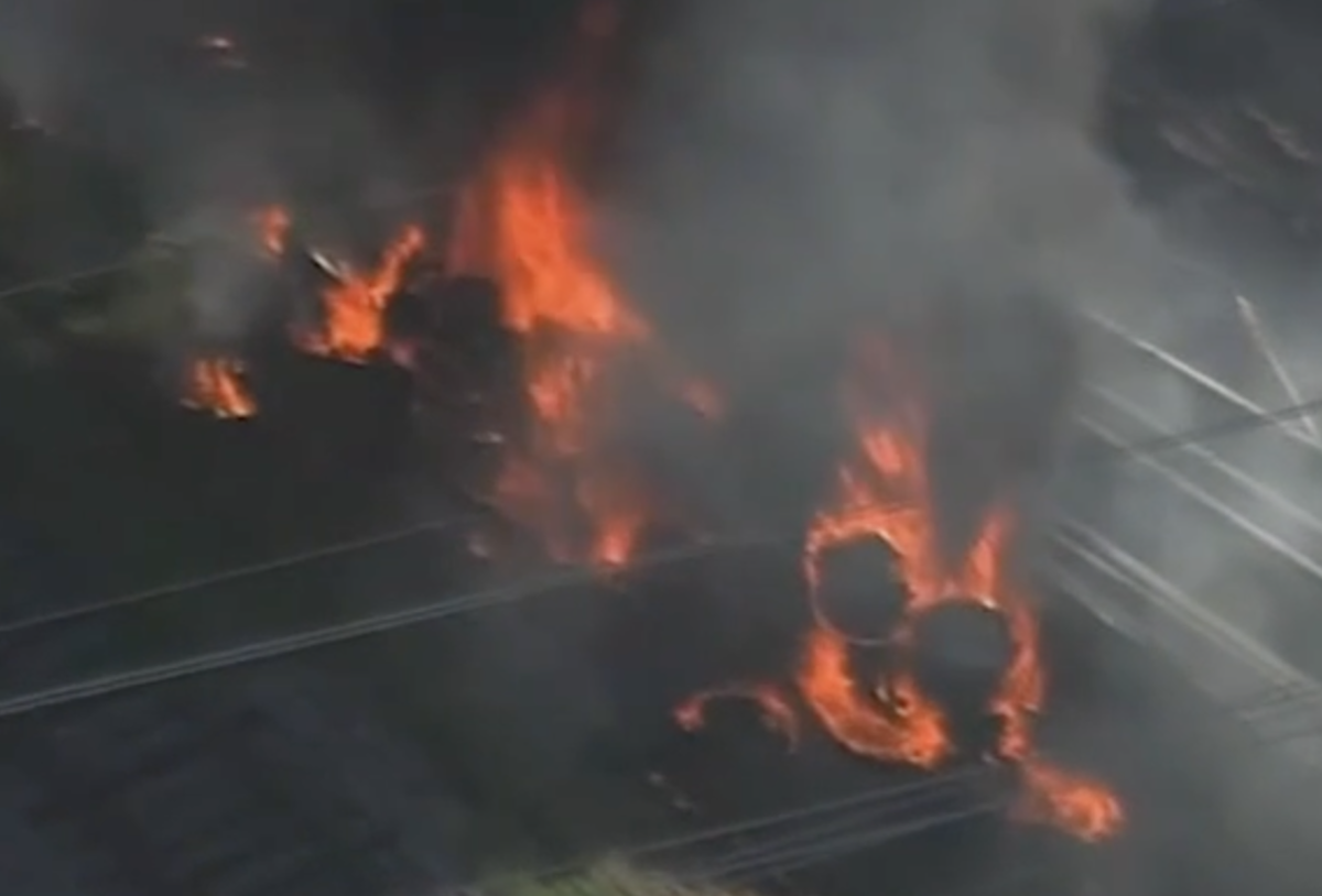 Men filmed pulling driver from flaming semi truck flipped upside down