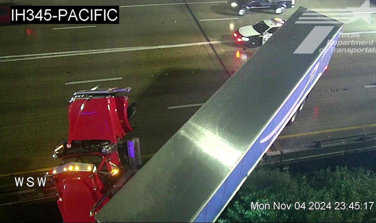 Rainy conditions send semi truck halfway off Dallas overpass