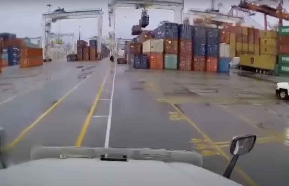 Video captures close call for trucker after crane knocks container off stack