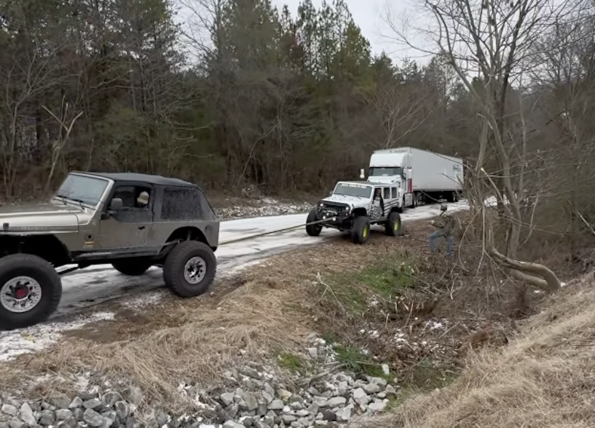 Watch a team of Jeeps haul a semi truck up an icy hill