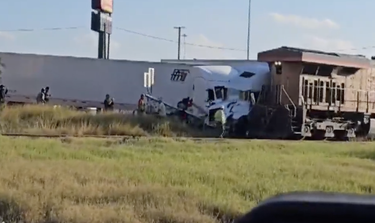 Train crashes into two semi trucks