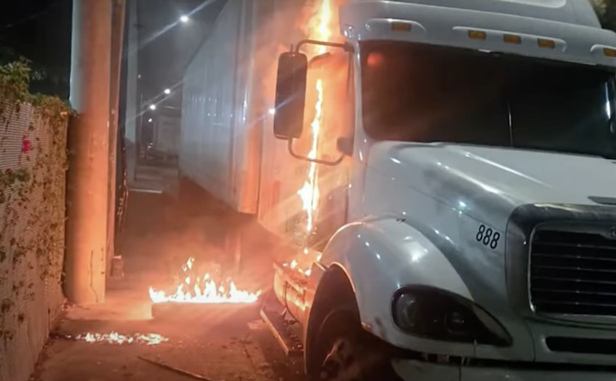 Sleeping driver escapes flaming truck in possible arson