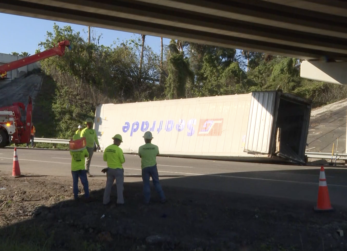 Truck loses trailer off overpass, squashing front end of Jeep