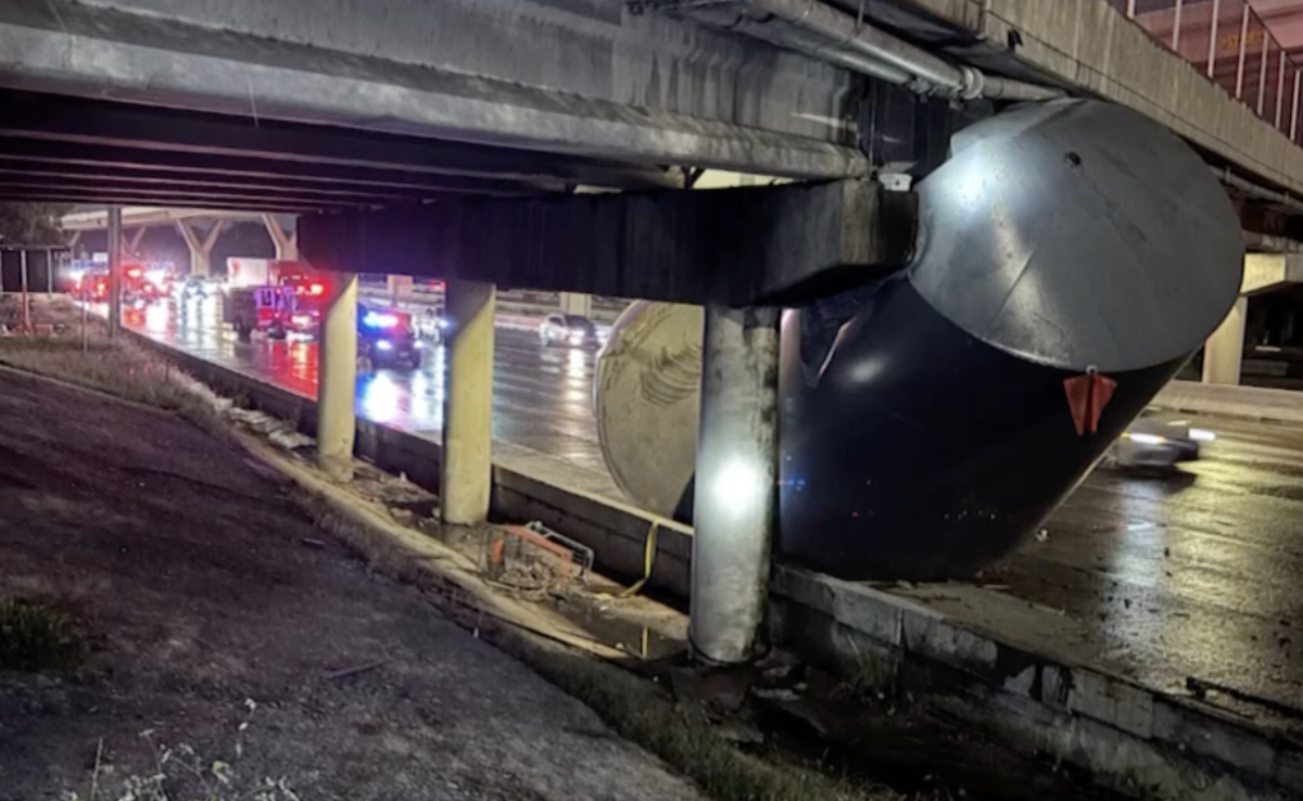 Large cylinder left wrapped around Houston Ave bridge in oversize load miscalculation