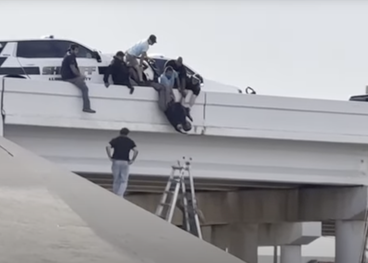 Watch bystanders rescue deputy pinned hanging upside down by his ankles after semi truck slams into patrol car