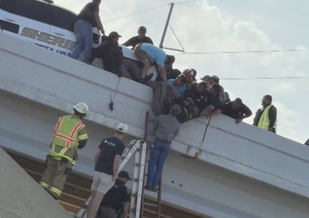 Lawsuit filed in incident involving distracted truck driver that left deputy dangling upside down from an overpass