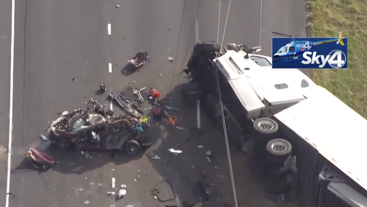 One dead, three injured in crash between three Chevy pickups and a tractor trailer