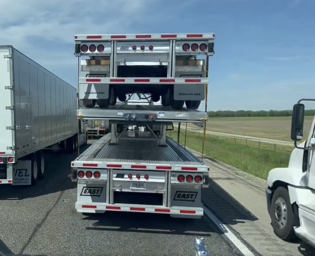 Drivers work together to block the path of a rig trying to pass stopped traffic on the shoulder