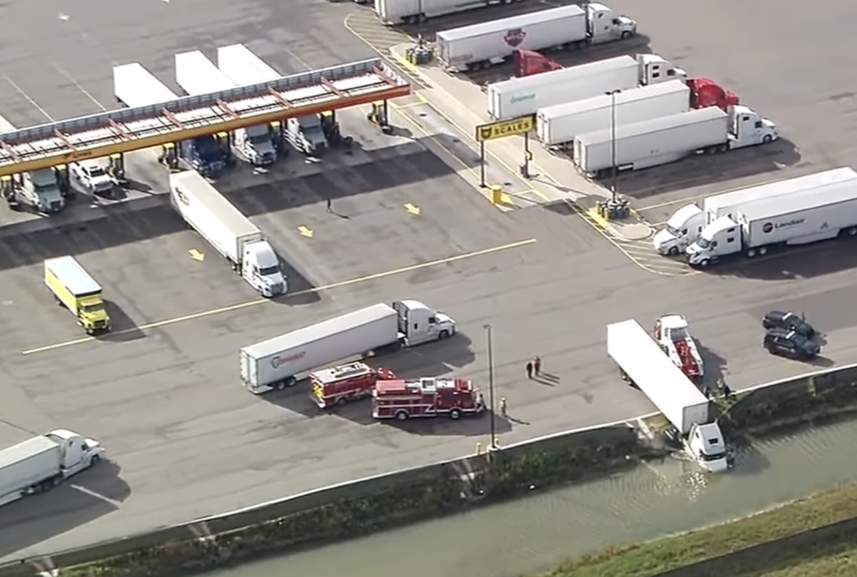 Forgotten parking brake sends semi truck into truck stop pond