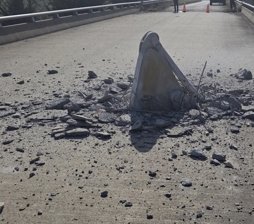 Excavator hauled by semi truck pops through bridge deck following strike in Kansas