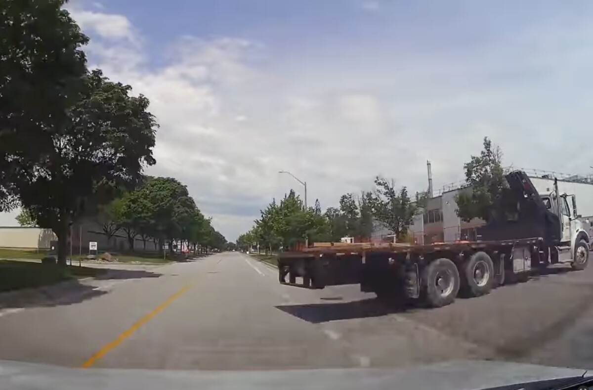 Dash cammer collides with commercial truck backing out of drive into traffic
