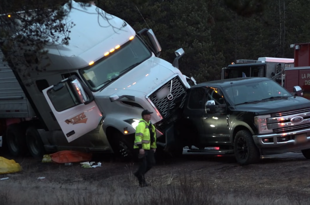 Semi truck left resting on bed of pickup after multi vehicle crash