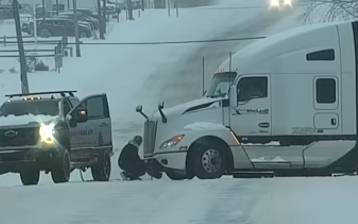 Watch a pickup truck lend a semi truck a helping hand in icy conditions