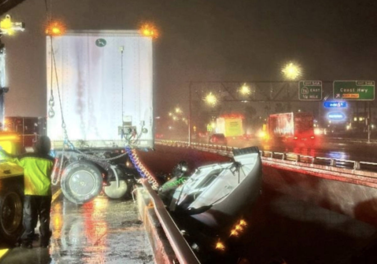 Wet conditions send semi truck sliding over guardrail 70 feet above the ground