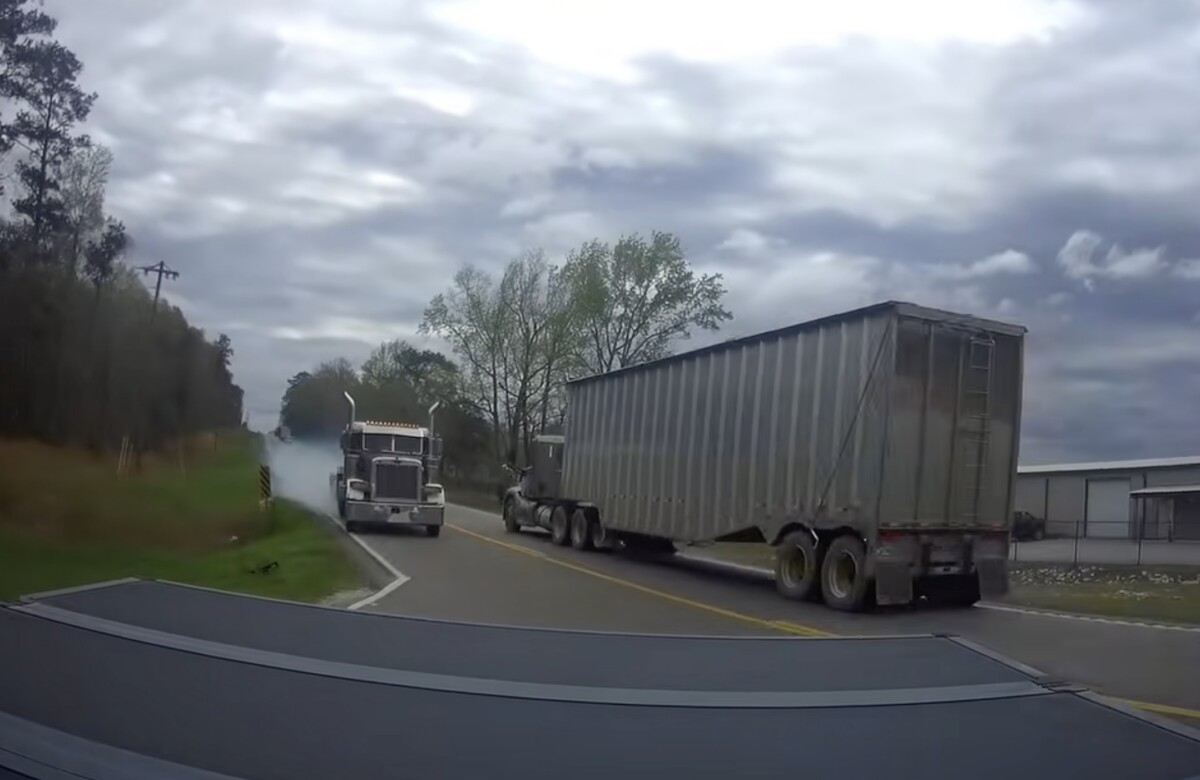 Video shows car driver scoot out of the way to avoid apparent runaway semi truck