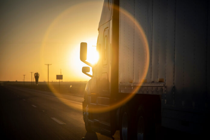 Long Haul 18 Wheel Truck at sunrise or sunset
