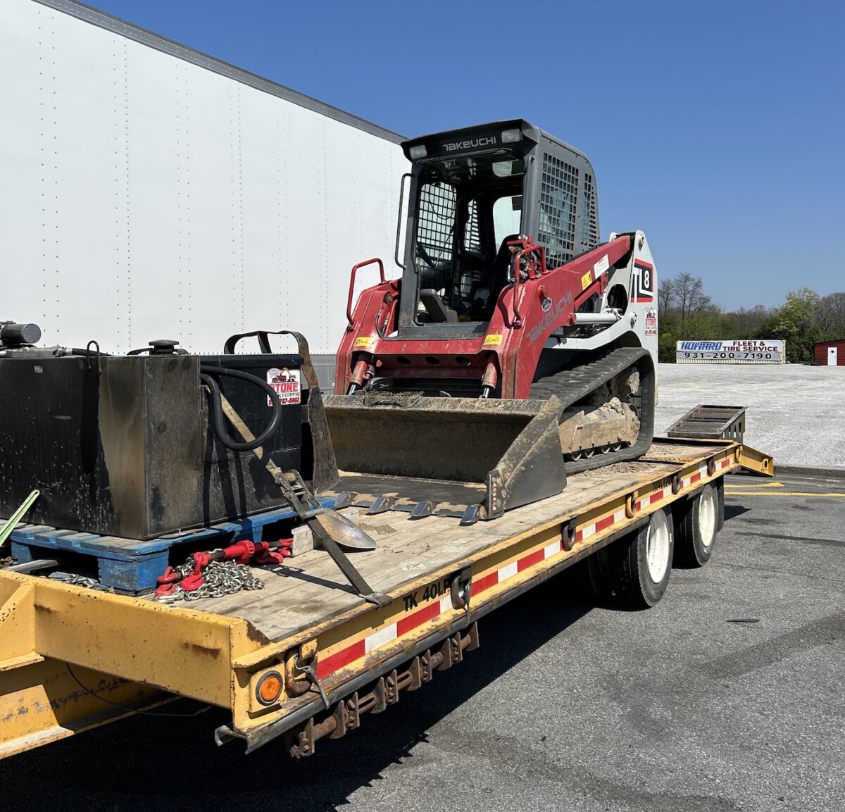 Tennessee troopers stop commercial vehicle hauling skid steer for no load securement or registration, brake violations