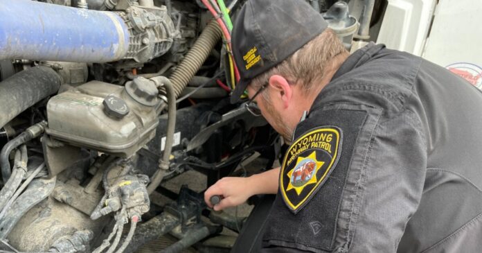 WHP Wyoming Highway Patrol trooper inspects commercial vehicle