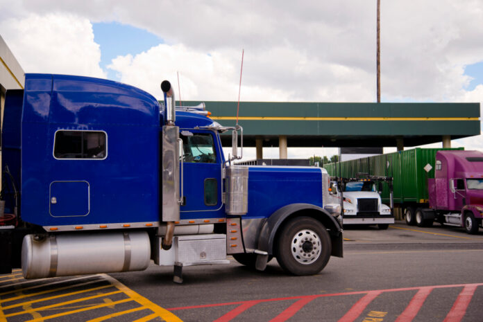 Blue semi truck rig on truck stop side view Semi Truck At Truck Stop