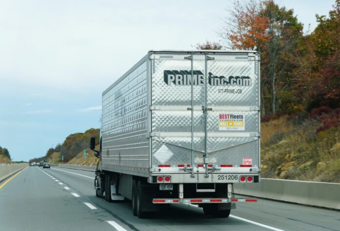 Pennsylvania, U.S.A - Oct 18, 2025 - A Prime Inc semi-trailer truck moving on the highway with autumn foliage visible on the roadside.
