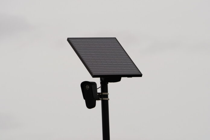 Flock safety police law enforcement license plate reader set up outside to help catch vehicle speeders.