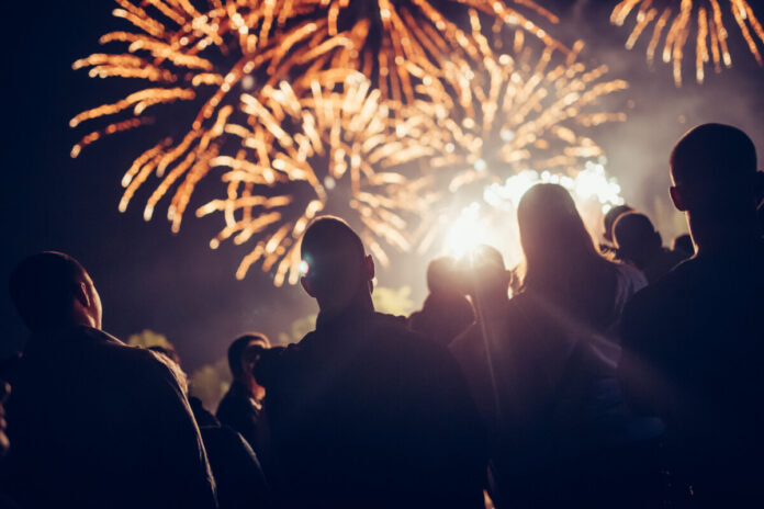 Crowd watching fireworks Crowd watching fireworks and celebrating at night