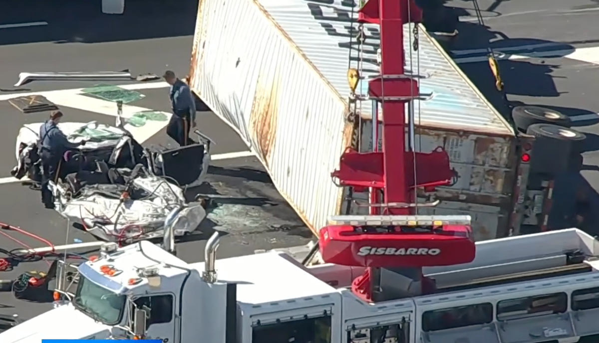 Truck overturns swerving to avoid traffic, fatally flattening car