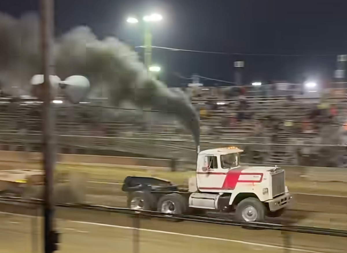 Semi truck crashes through barrier at truck pull event after pulling away from sled in spectator video