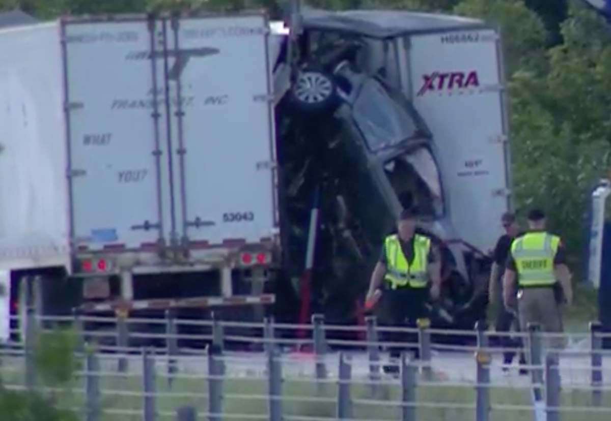 Family expected to recover after semi truck slams into slowed traffic, wedging car upright against second big rig